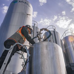 An employee checks the fermentation process in the 1000L bioreactors, next to the 30,000L bioreactors at MiAlgae's Commercial Demonstrator site.