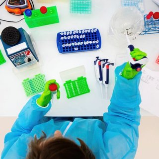 Scientist-with-PPE-working-on-microorganisms-seen-from-above-1-1024x683