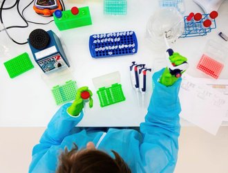 Scientist-with-PPE-working-on-microorganisms-seen-from-above-1-1024x683