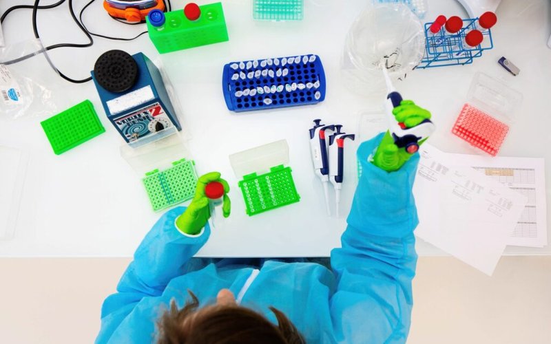 Scientist-with-PPE-working-on-microorganisms-seen-from-above-1-1024x683